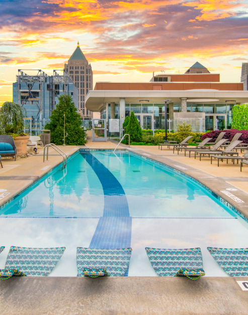 Rooftop swimming pool with sundeck next to community clubhouse at MAA Midtown luxury apartments in Atlanta, GA