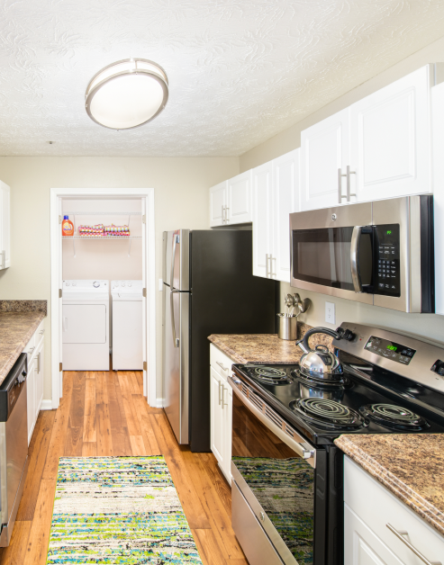 Model kitchen with wood floors and upgraded appliances at MAA Mount Vernon luxury apartments in Sandy Springs, GA
