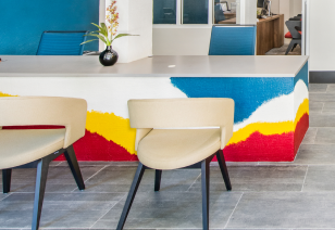 Clubhouse with stylish chairs next to colorful table counter at MAA Piedmont Park luxury apartments in Atlanta, GA