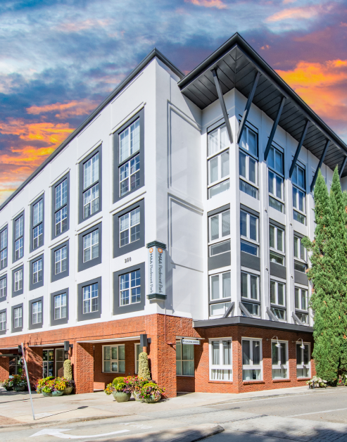 Corner view of exterior of apartment complex with a sunset sky at MAA Piedmont Park luxury apartments in Atlanta, GA
