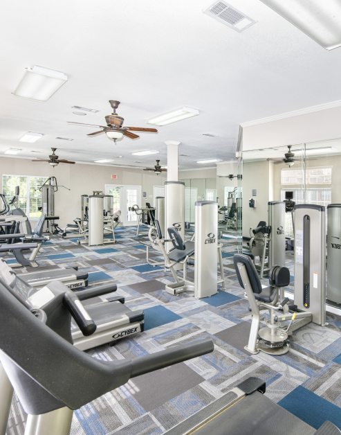 Modern fitness center with weight machines and treadmills at MAA Pleasant Hill luxury apartments in Duluth, GA