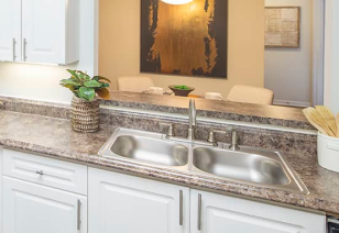 Modern kitchen with stainless steel sink at MAA Pleasant Hill luxury apartments in Duluth, GA