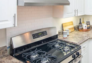 Modern kitchen with upgraded stove and oven at MAA Pleasant Hill luxury apartments in Duluth, GA