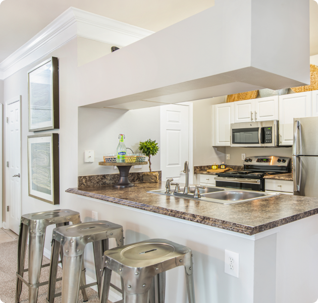 Modern kitchen with granite countertop bar top and upgraded appliances at MAA Prescott luxury apartments in Duluth, GA