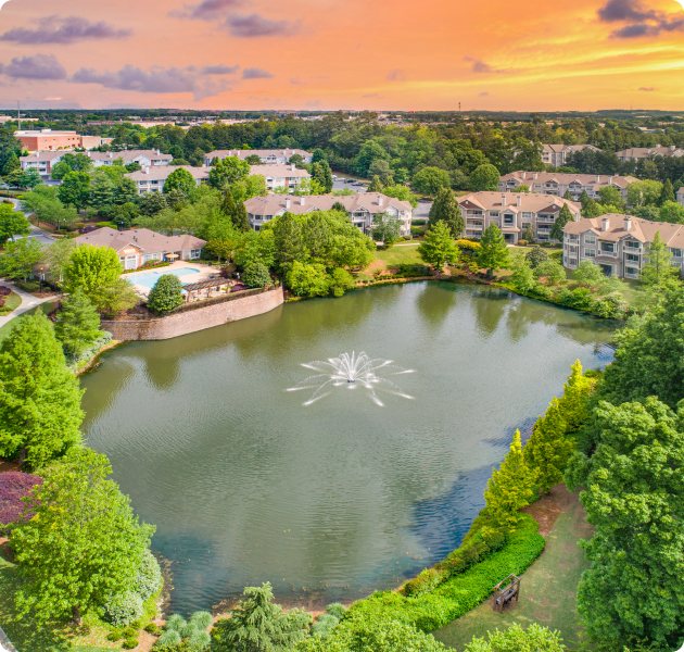 Aerial view of lake with fountain at MAA Prescott luxury apartments in Duluth, GA