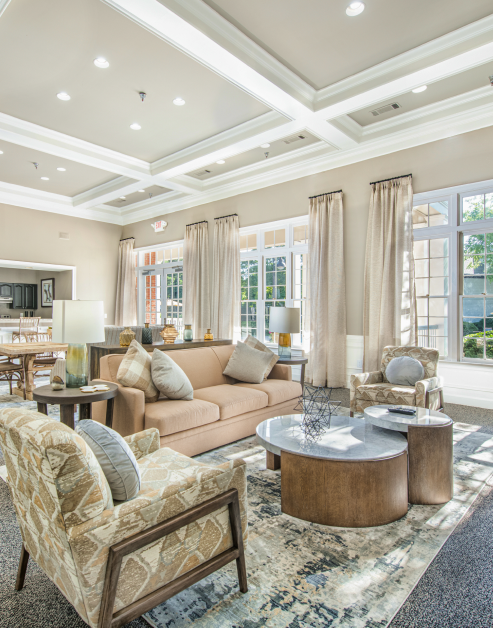 Community clubhouse lounge sitting area with sofa couch and modern coffee table at MAA River Oaks luxury apartments in Duluth, GA