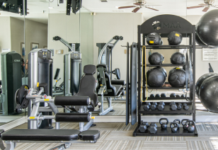 Community fitness center with free weights and weight machines at MAA River Oaks luxury apartments in Duluth, GA
