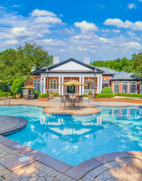 Swimming pool next to community clubhouse at MAA River Oaks luxury apartments in Duluth, GA