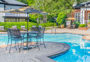 Poolside patio table and chairs at MAA River Oaks luxury apartments in Duluth, GA