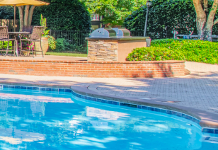 Poolside outside grilling station at MAA River Oaks luxury apartments in Duluth, GA
