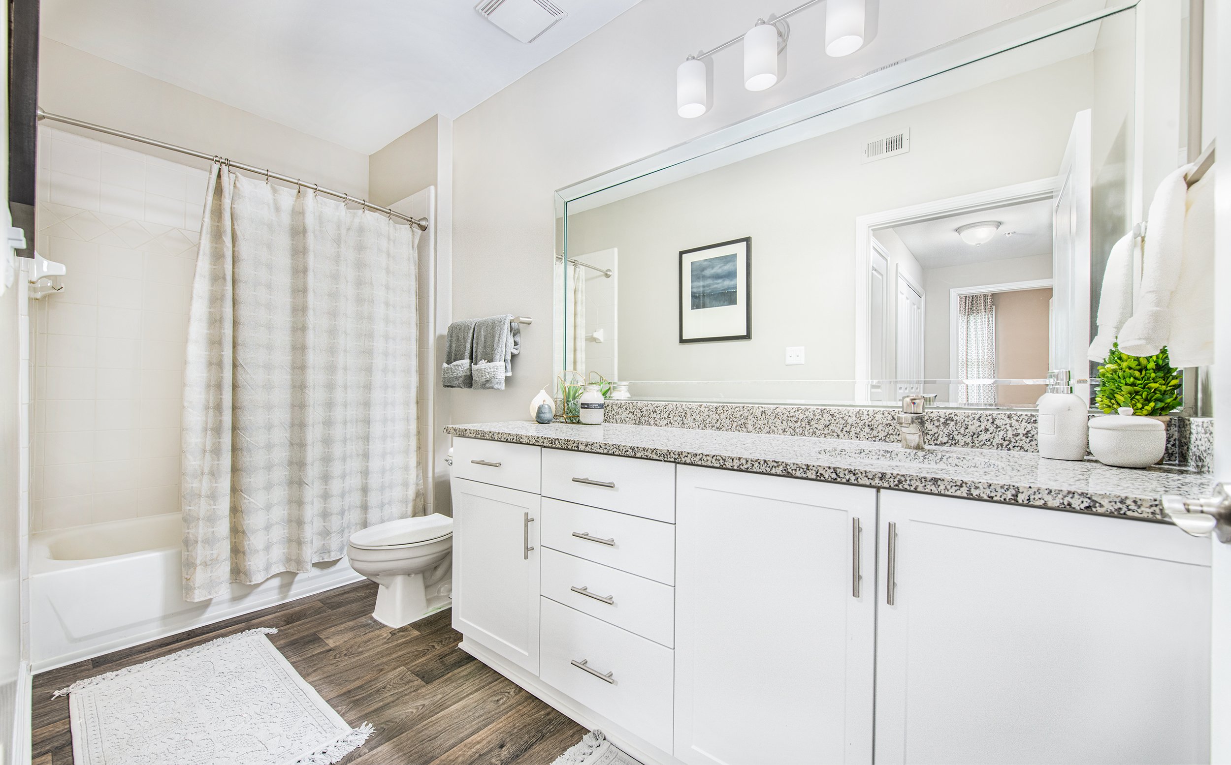 Upscale white bathroom with granite countertops at MAA Riverside luxury apartments in Atlanta, GA