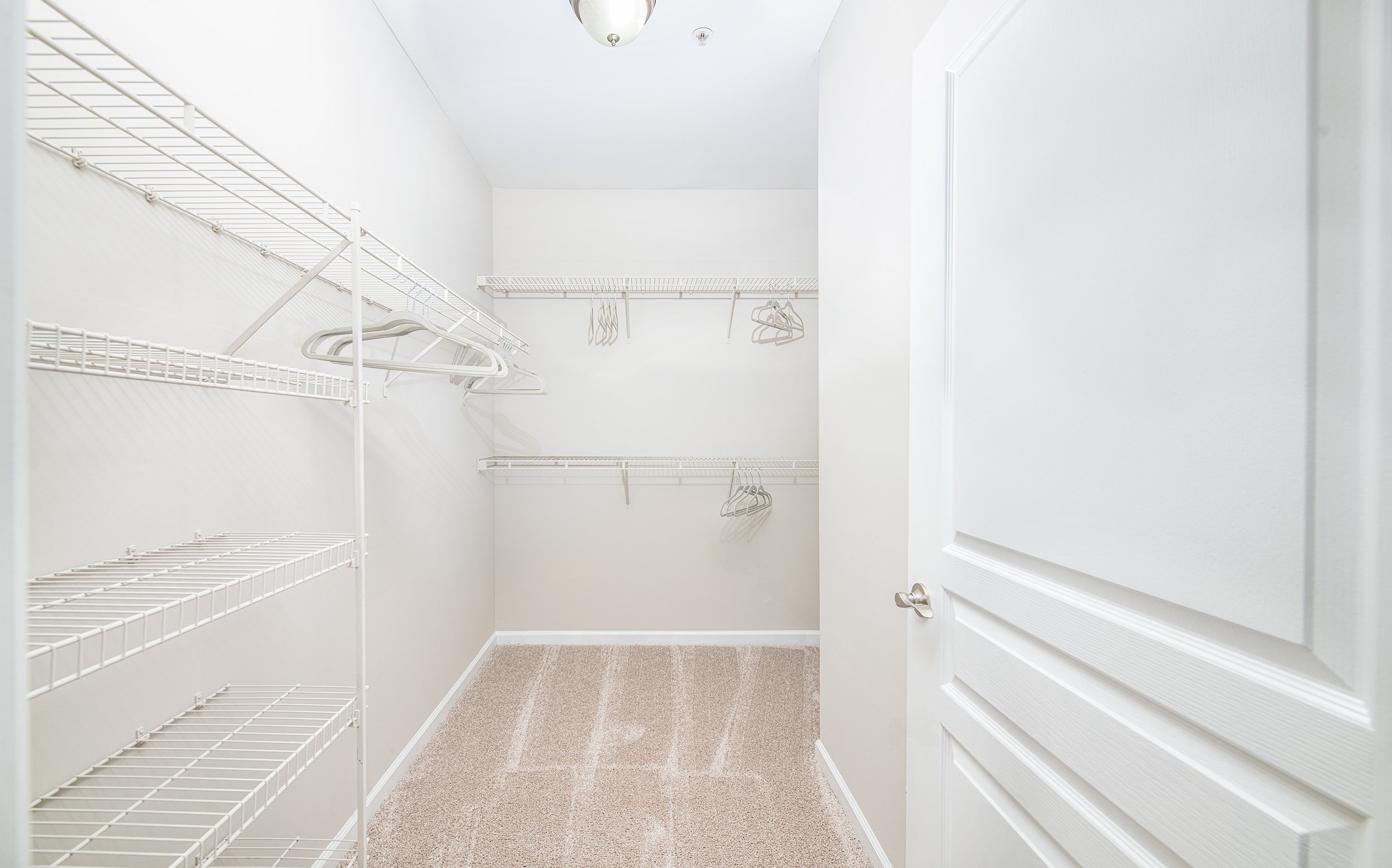 Spacious multi-shelf walk-in closet of a unit at MAA Riverside luxury apartments in Atlanta, GA