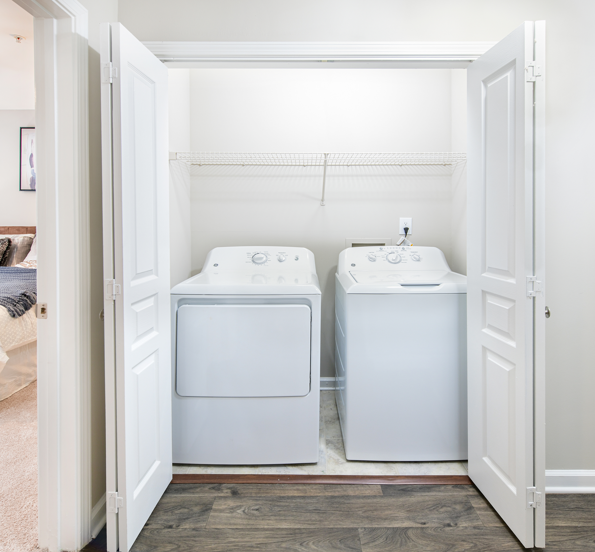 Laundry room with full sized washer/dryer and accordion doors at MAA Riverside luxury apartments in Atlanta, GA