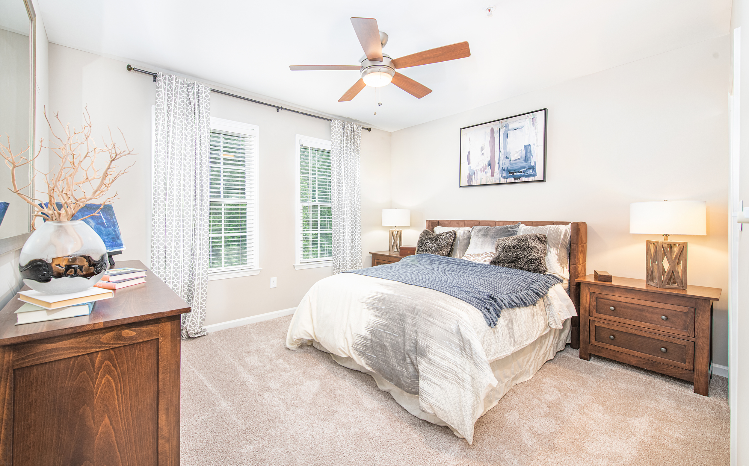 Model bedroom with natural filtered light and rustic wood bed set at MAA Riverside luxury apartments in Atlanta, GA