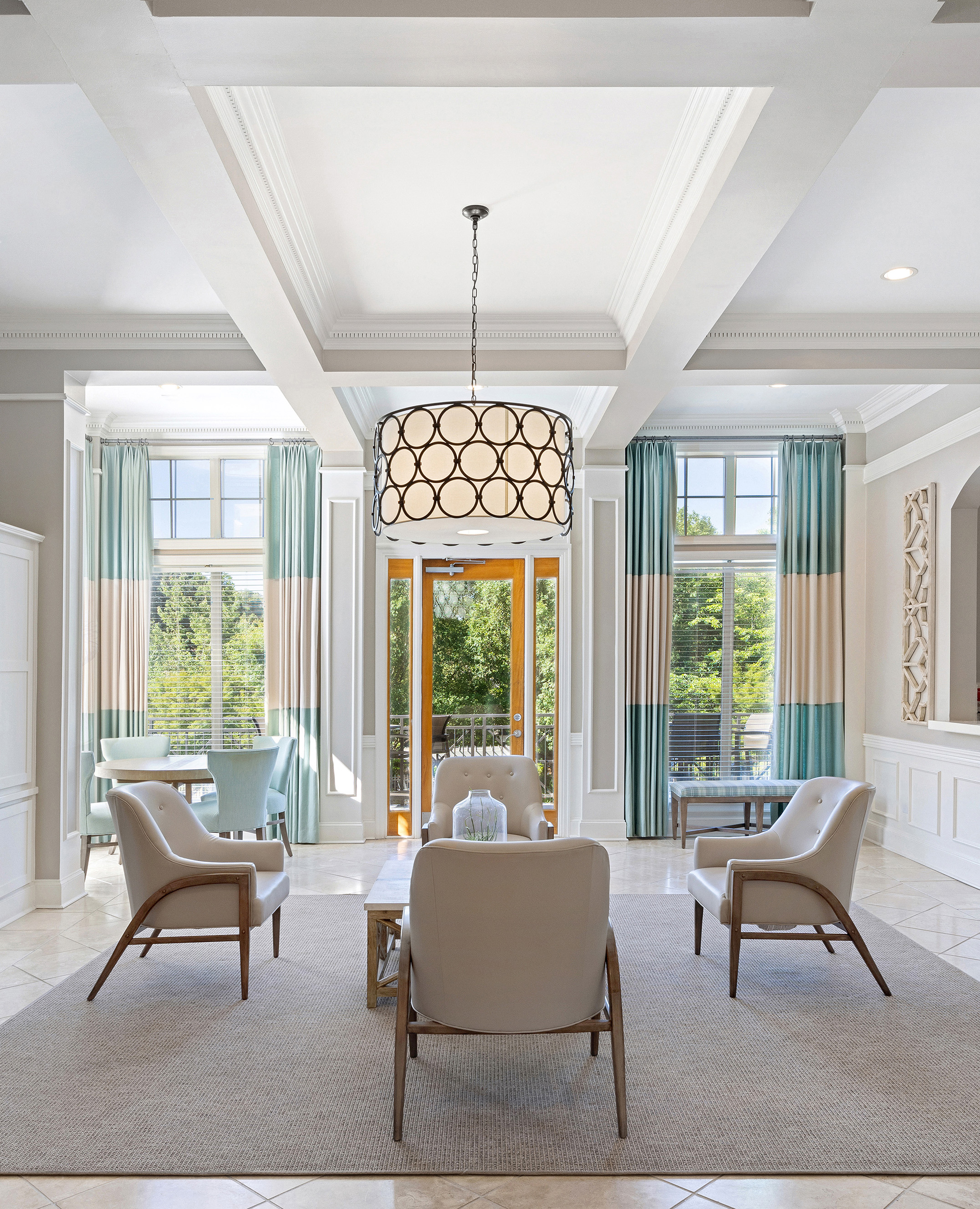Luxurious community clubhouse with tall ceiling picture windows, sitting area and stylish lighting at MAA Shiloh luxury apartments in Kennesaw, GA