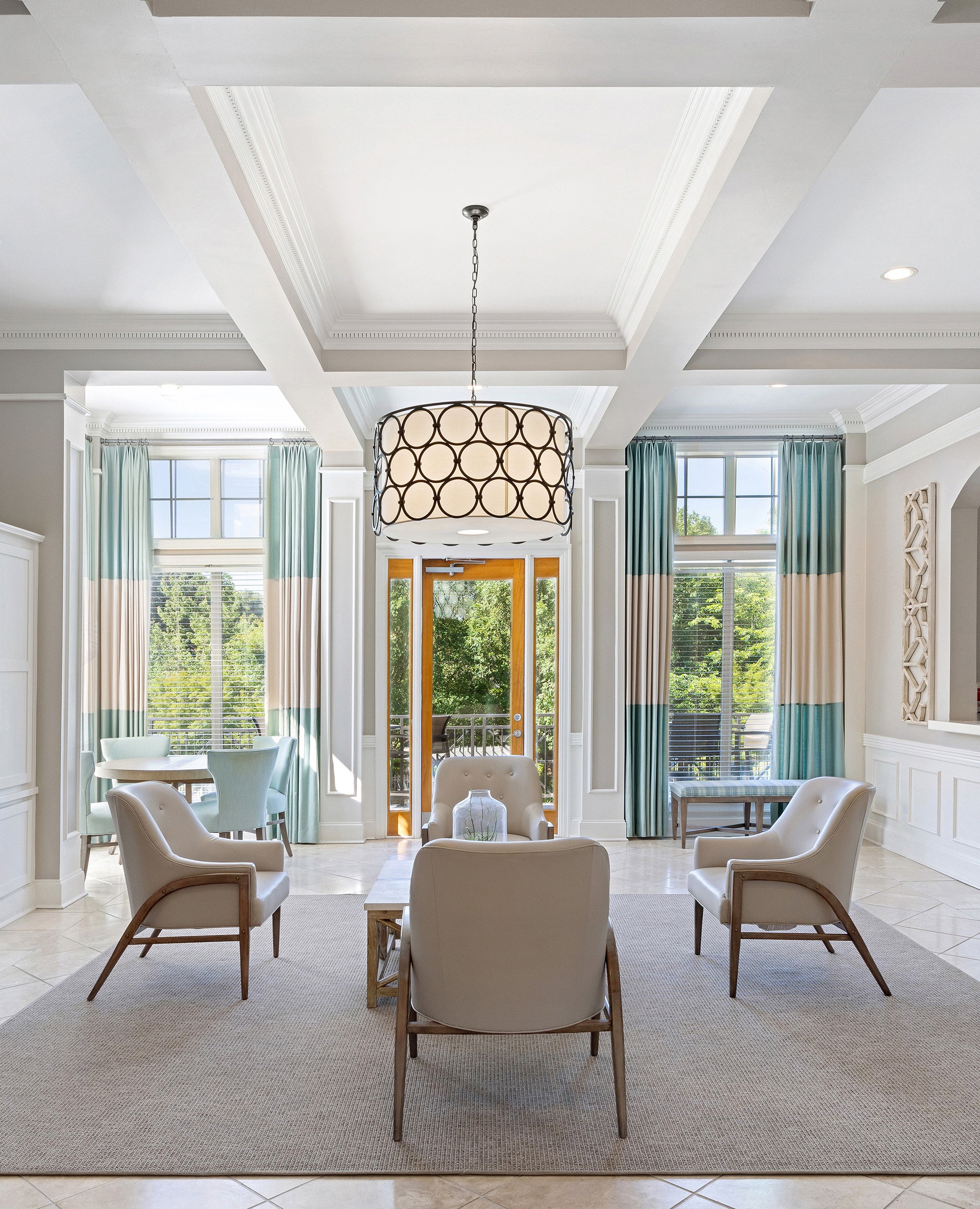 Luxurious community clubhouse with tall ceiling picture windows, sitting area and stylish lighting at MAA Shiloh luxury apartments in Kennesaw, GA