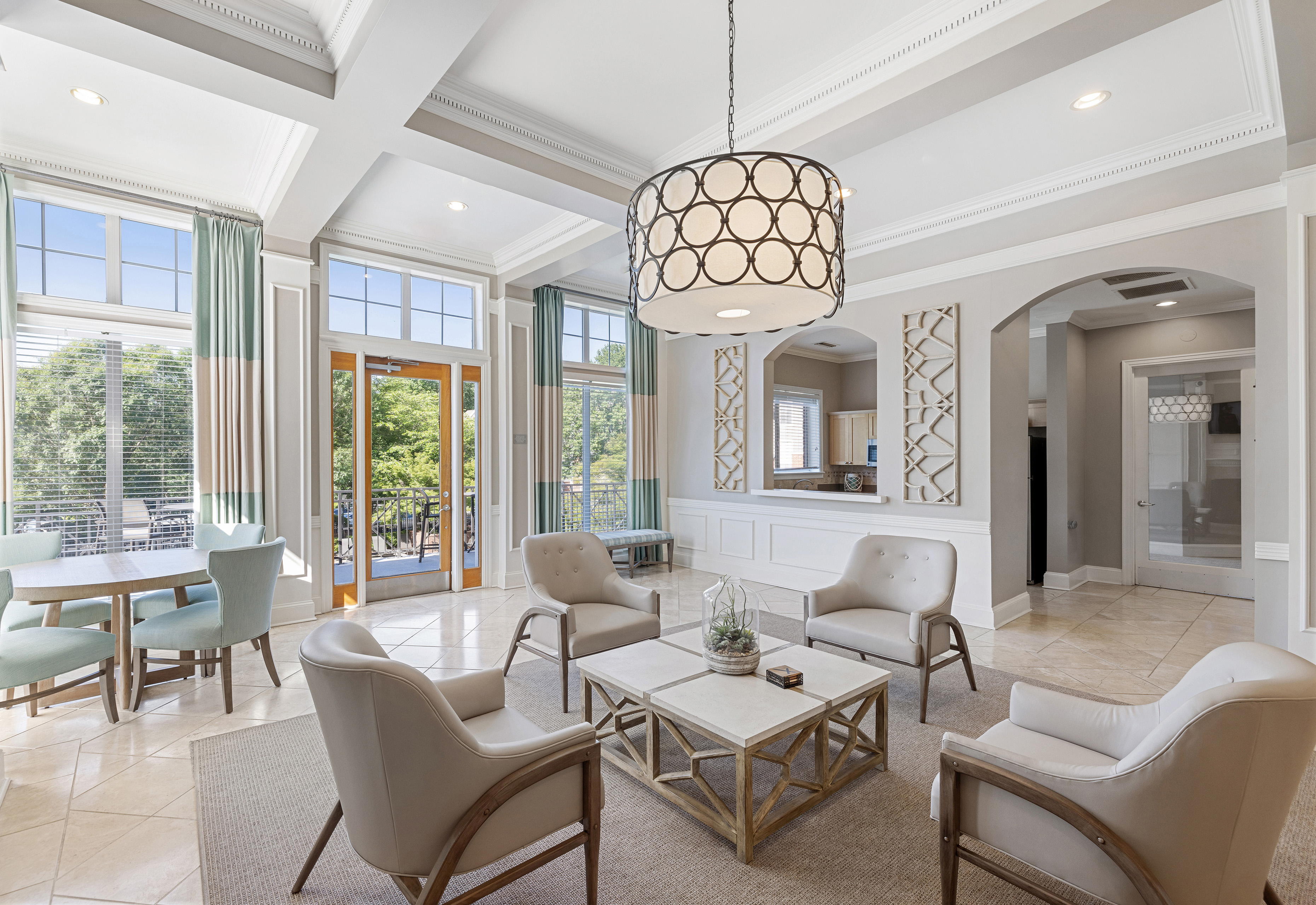Side view of community clubhouse sitting area with stylish circular hanging light fixture at MAA Shiloh luxury apartments in Kennesaw, GA