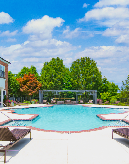 Swimming pool with lush trees and cabana at MAA Spring luxury apartments in Smyrna, GA
