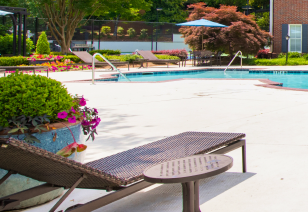 Poolside lounge chair and side table at MAA Spring luxury apartments in Smyrna, GA