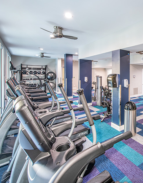 State-of-the-art fitness center with ceiling fans, weight machines and treadmills at MAA Stratford luxury apartments in Atlanta, GA