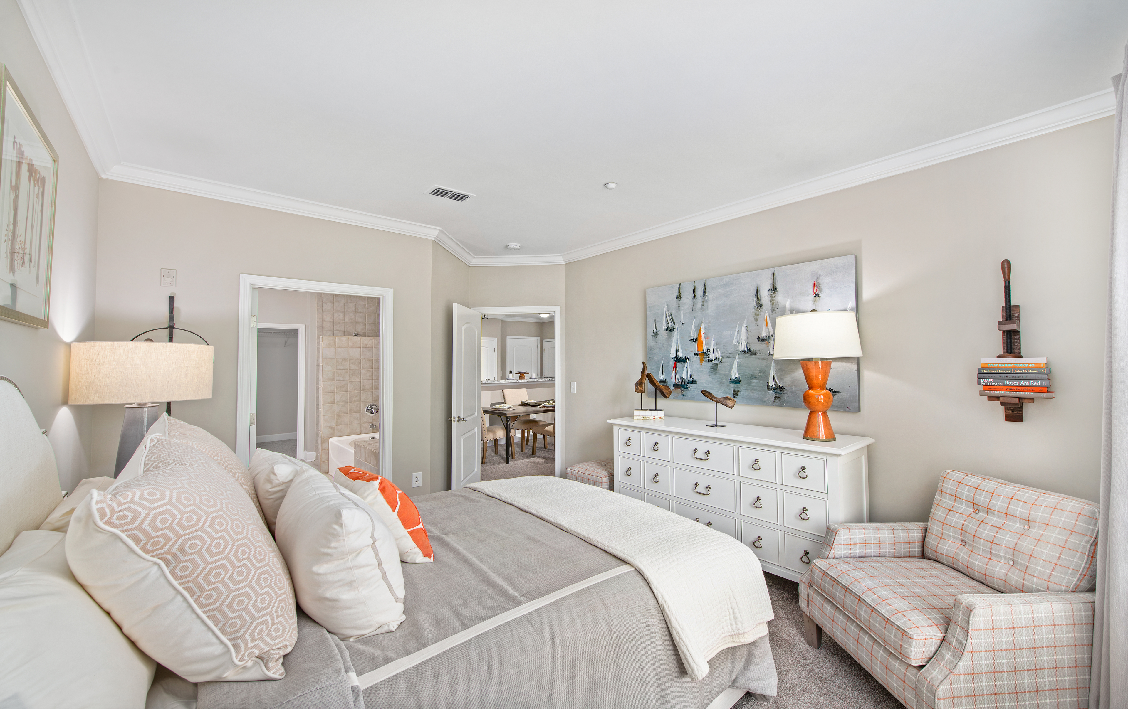 Second model bedroom with white dresser and sitting chair at MAA West Village luxury apartments in Smyrna, GA