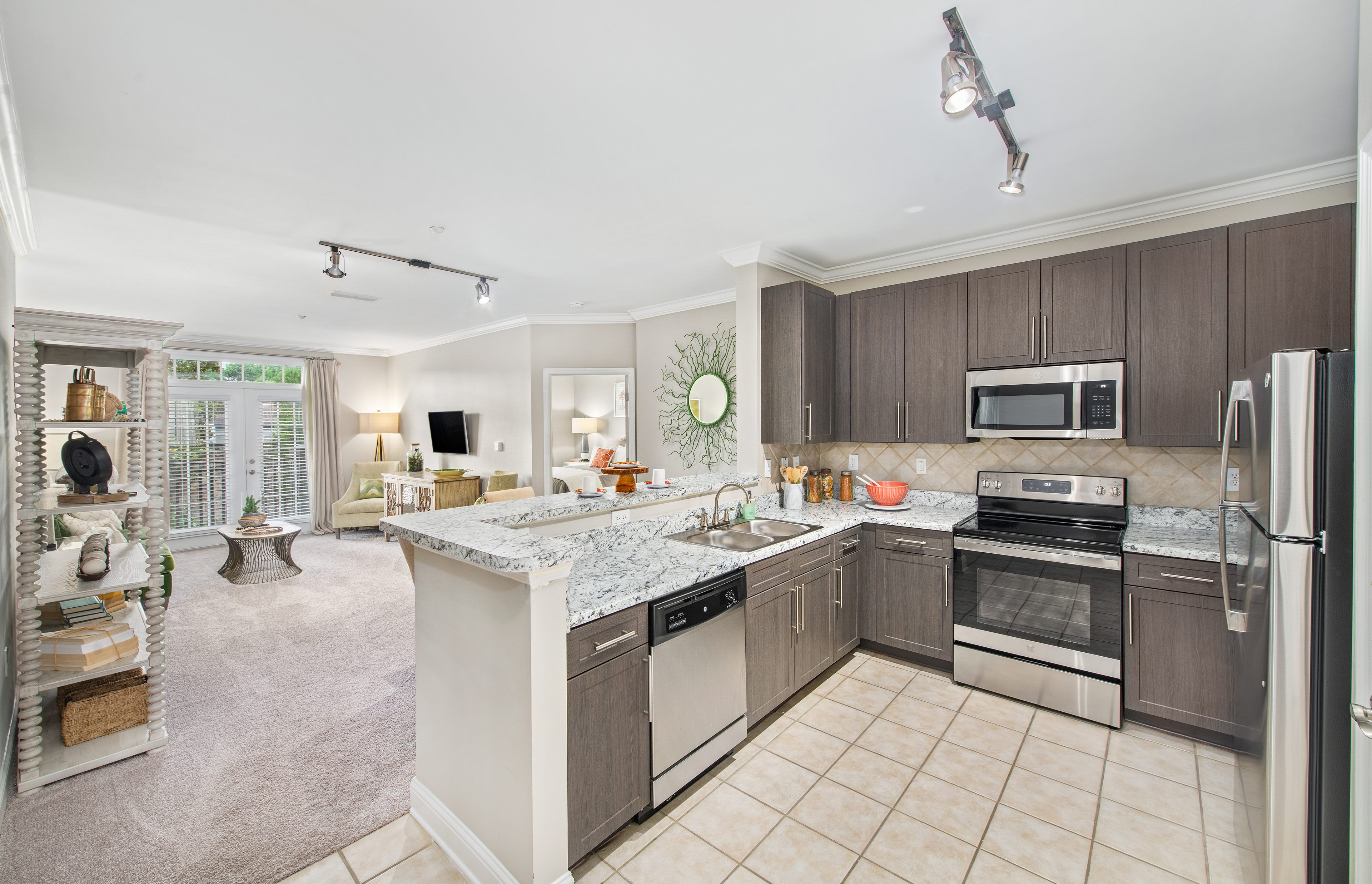 Model home view of kitchen and open living room space at MAA West Village luxury apartments in Smyrna, GA