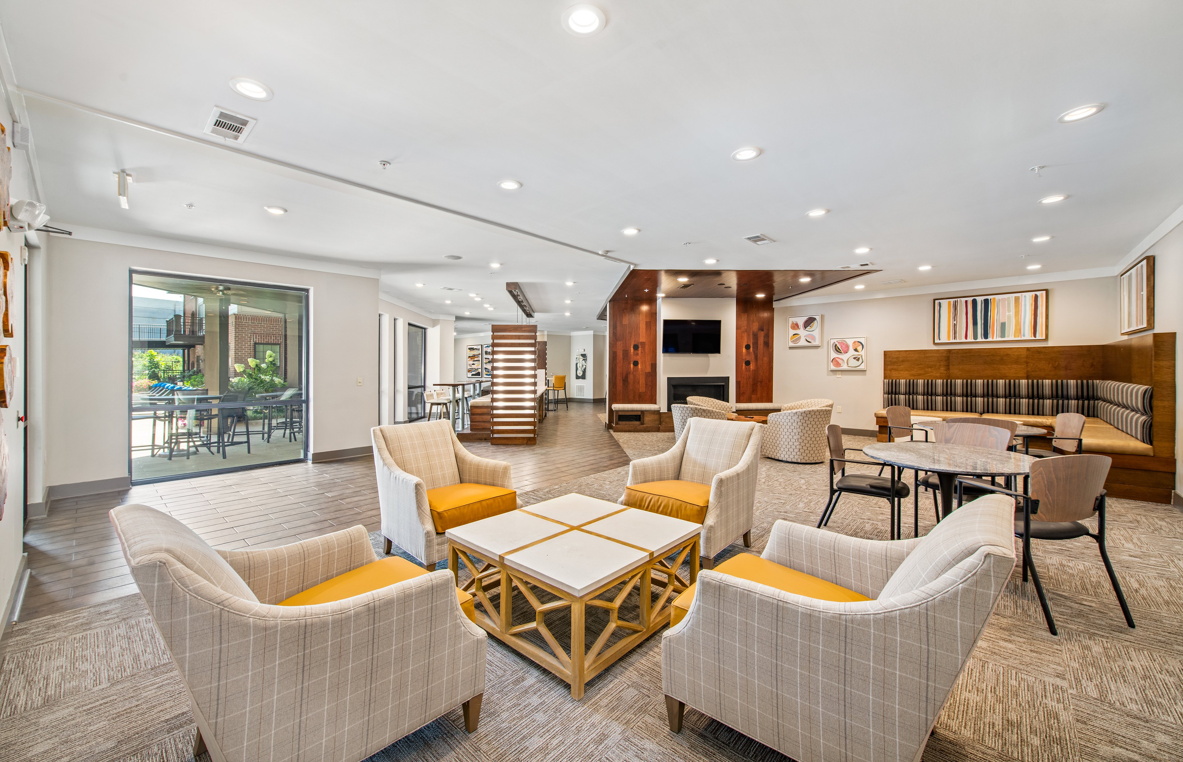 Community lounge area with booths, tables and chairs at MAA West Village luxury apartments in Smyrna, GA