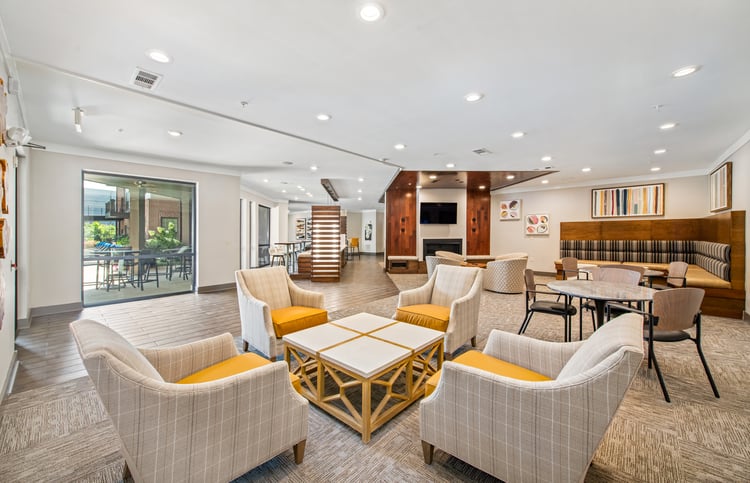Community lounge area with booths, tables and chairs at MAA West Village luxury apartments in Smyrna, GA