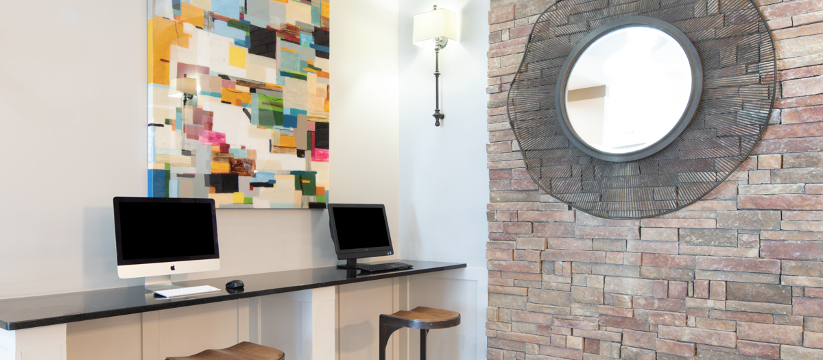 Business center with computer workstations at MAA West Village luxury apartments in Smyrna, GA