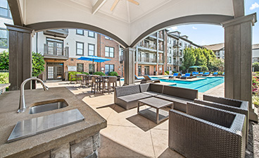 View of swimming pool from covered lounge area at MAA West Village luxury apartments in Smyrna, GA