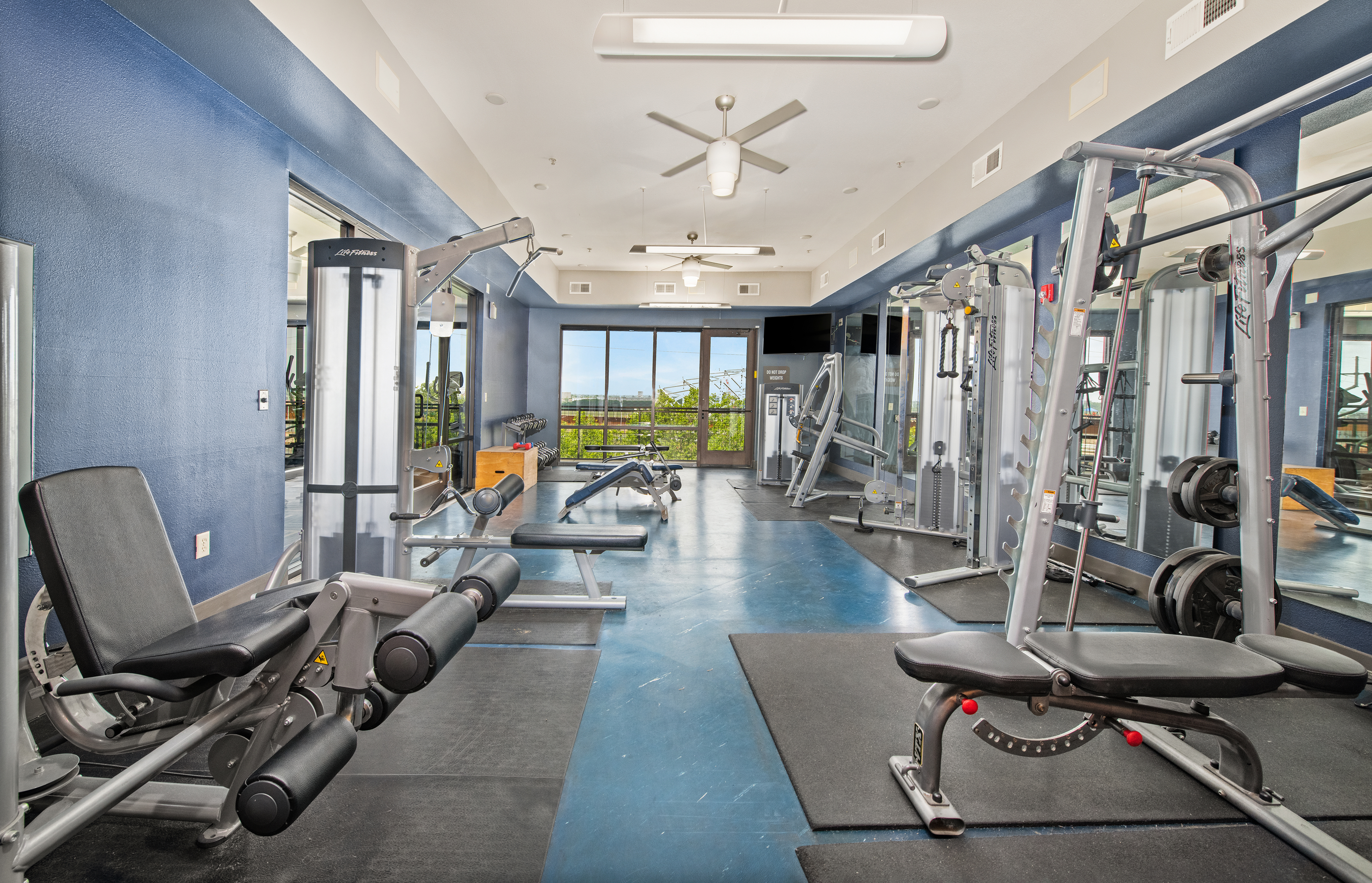 Fitness room with treadmills and weight machines at MAA The Station luxury apartments in Kansas City, MO