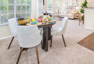 Kitchen area with dining table and chairs next to large window with blinds in living room at MAA Fifty-One luxury apartments in Matthews, NC