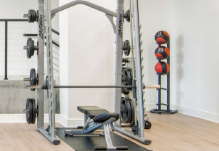 Fitness center with a smith weight machine and weighted medicine ball rack at MAA Gateway luxury apartments in Charlotte, NC