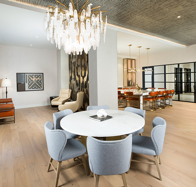 Modern clubhouse with resident gathering spaces with multiple seating areas at MAA Liberty Row luxury apartments in Charlotte, North Carolina.