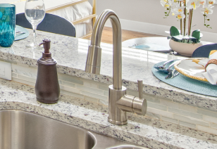 Close up of kitchen bar top counter and stainless steel kitchen sink faucet at MAA Uptown luxury apartments in Charlotte, NC