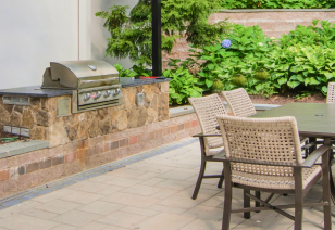 Poolside outside grill station with patio table area at MAA Uptown luxury apartments in Charlotte, NC