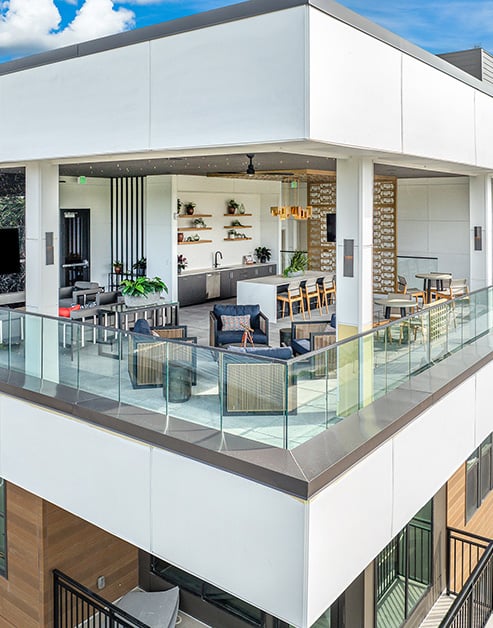 Top floor corner view enclosed terrace with multiple sitting areas, communal kitchen and stylish lounge areas at MAA Nixie luxury apartments in Durham, NC