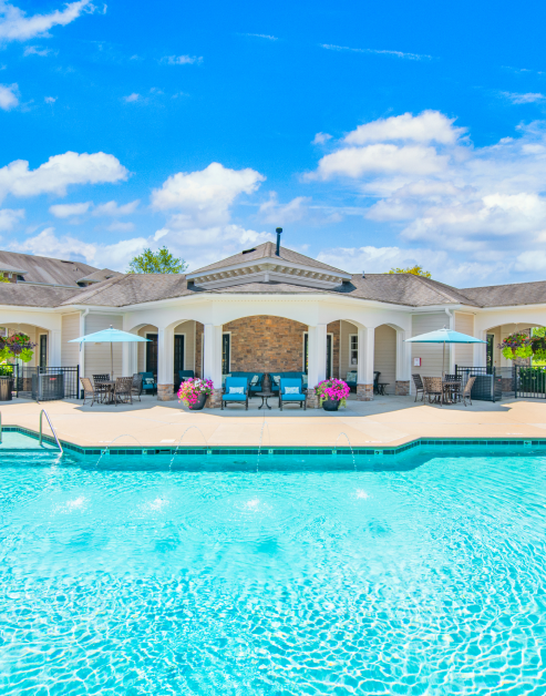 Resort-style pool next to the community clubhouse with multiple siting areas at MAA Kennesaw Farms luxury apartments in Gallatin, TN