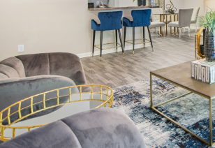 Close up view of living room sitting area on wood floors, next to an open kitchen at MAA Nashville West luxury apartments in Nashville, TN