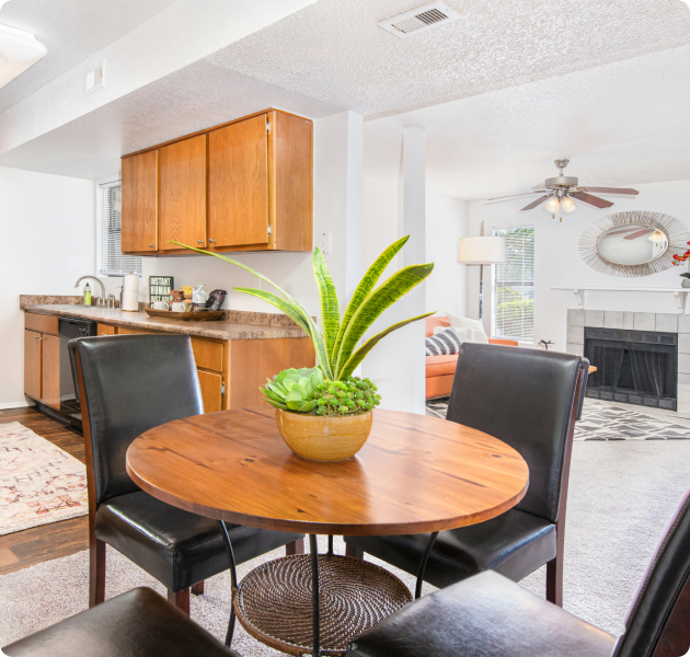 Model apartment with carpeted living and dining area next to an open kitchen at MAA Park luxury apartments in Hermitage, TN