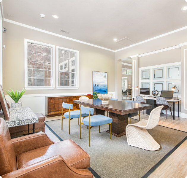 Leasing office featuring multiple contemporary seating areas, sleek flooring, and a front desk with computers for customer service at MAA Canyon Pointe luxury apartments in Austin, TX