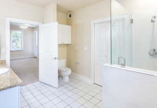 Modern bathroom with a sleek shower with glass door, toilet, and sink at MAA Abbey luxury apartments in Dallas, TX