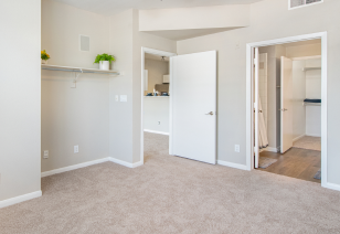 Spacious empty master bedroom with en suite bathroom at MAA Addison Circle luxury apartments in Addison, TX