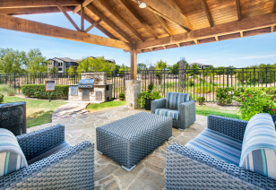Poolside pergola seating area with a center table at MAA Fairview luxury apartments in Fairview, TX