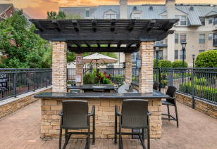 Outdoor poolside patio area with a pergola, bar seating at MAA Meridian luxury apartments in Dallas, TX