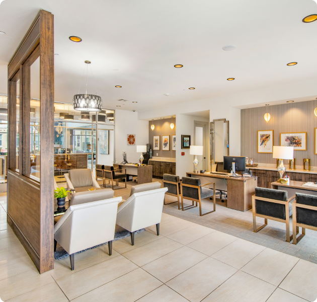 Leasing office featuring multiple contemporary seating areas, sleek flooring, and a front desk with computers for customer service at MAA Afton Oaks luxury apartments in Houston, TX