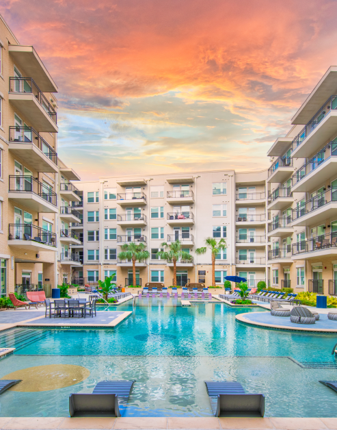 Resort-style pool situated in middle of apartment complex with poolside dining areas and sundecks at MAA Afton Oaks luxury apartments in Houston, TX