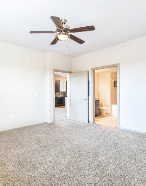 Empty bedroom with a ceiling fan and an ensuite bathroom at MAA Vintage Park luxury apartments in Houston, TX