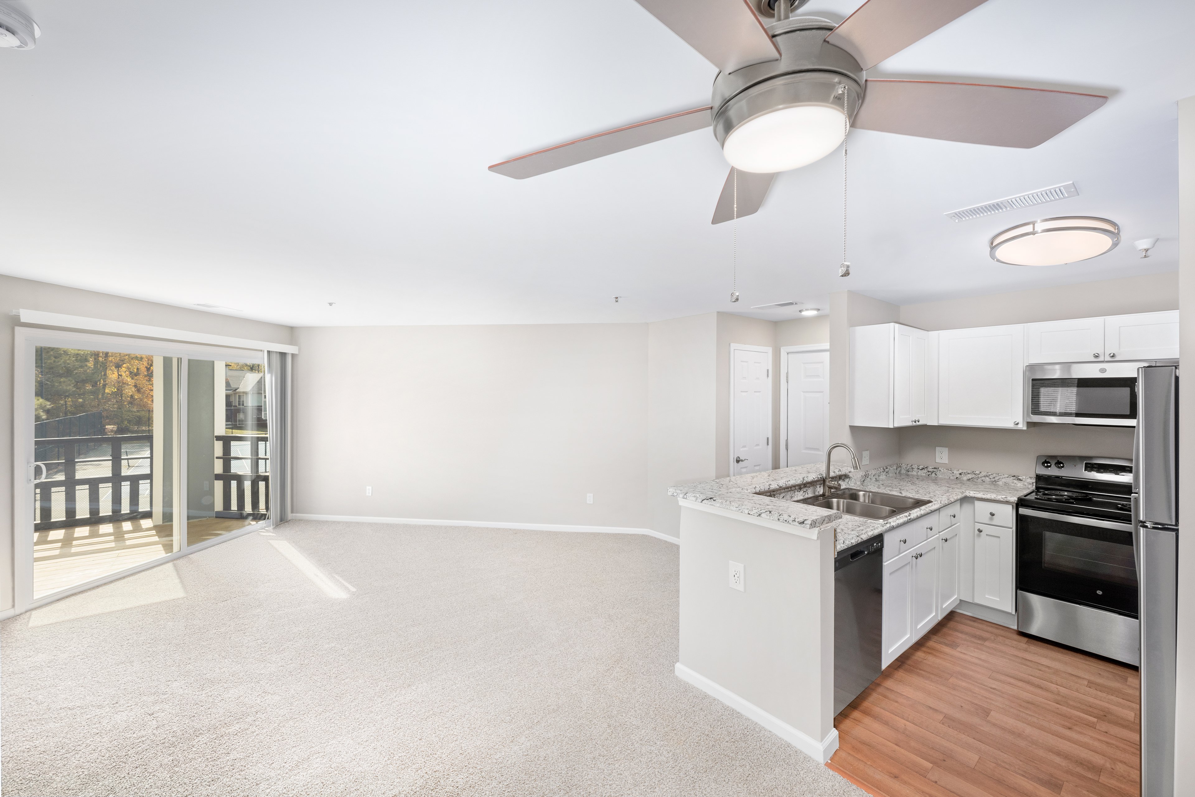 Model - Kitchen and living room - at MAA Pavilion Place luxury apartment homes in Richmond, VA