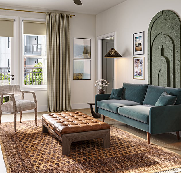 Modern apartment living room with a blue sofa next to a tufted bench on a patterned area rug and accent chairs, floor lamps, next to large windows overlooking the courtyard at MAA Rove luxury apartments in Richmond, VA